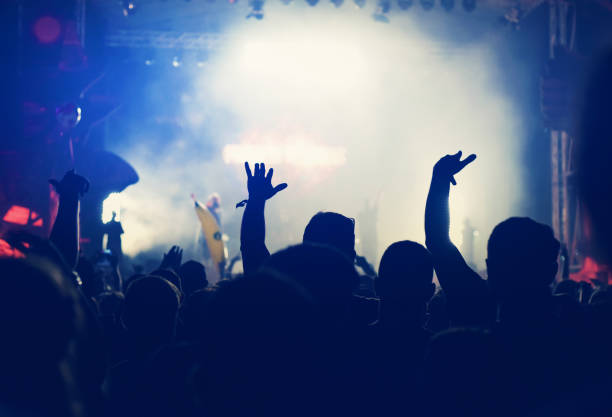 istock Crowd with arms outstretched at concert 882652610