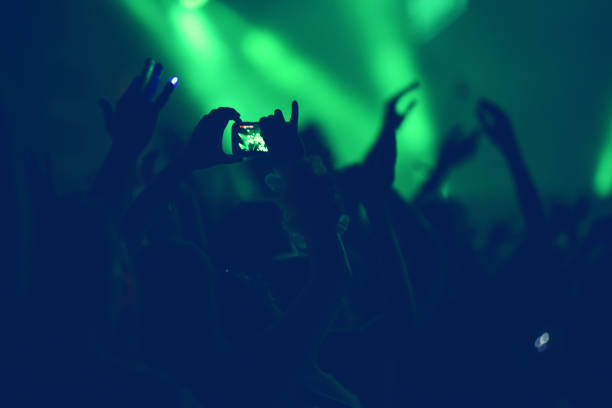 istock Crowd with arms outstretched at concert 882652624