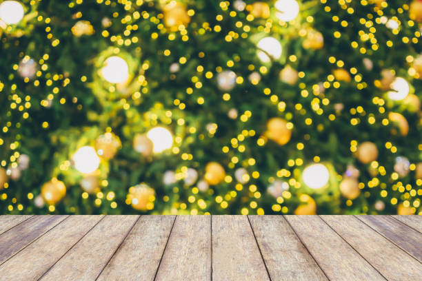 istock Abstract Christmas holiday bokeh light background with empty wood table for create montage product 882653300