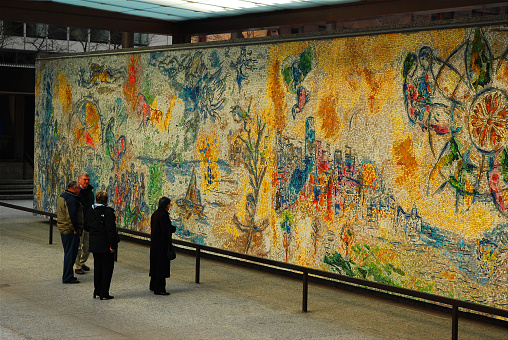 Chicago, IL, USA April 8, 2008 Four adults stop to admire the public display of Marc Chagall's mosaic Four Seasons in Chicago.  The city of Chicago mandates that all new construction dedicate funds and space to display works of art to the public