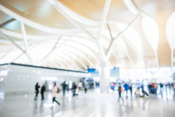istock Defocused Travellers in the Airport with Luggages 882660876
