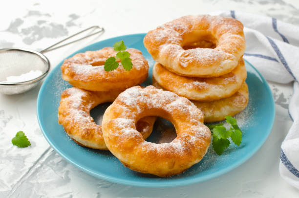 istock Homemade fried vanilla cottage cheese donuts on a white concrete background 882669768