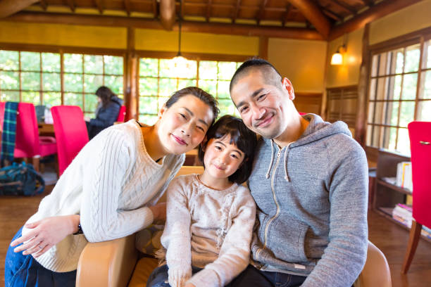 istock Asian family having fun time in cafe 882671008