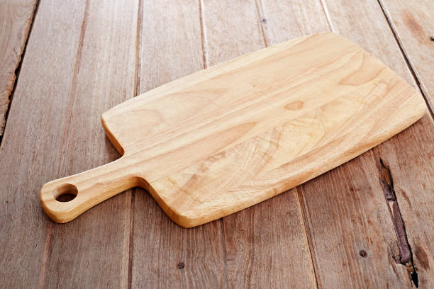 istock Wood cutting board on wooden background 882676334