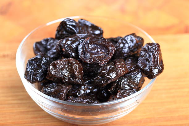 istock Prunes in clear glass bowl 882687402