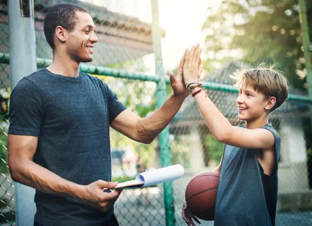 Photo of Young basketball player shoot