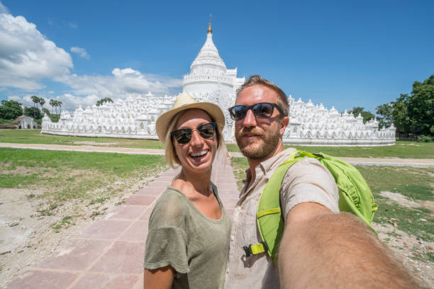 istock Travel couple taking selfie with white temple, Myanmar 882693584