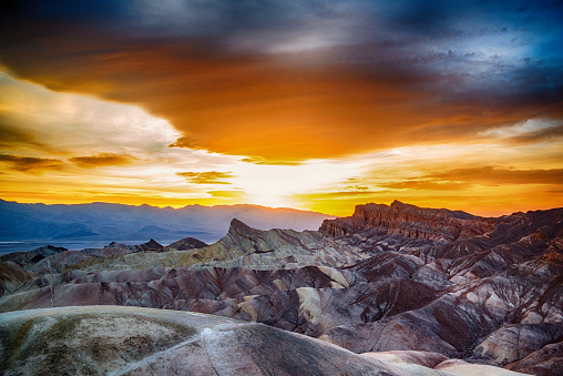 The sun setting at Zabriskie Point, which appears as though on a different planet, in Death Valley National Park.