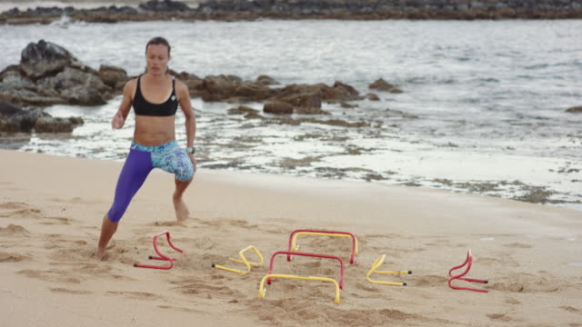 4K Slow Mo: Fit Hawaiian Woman Doing Agility Exercise on a Beach