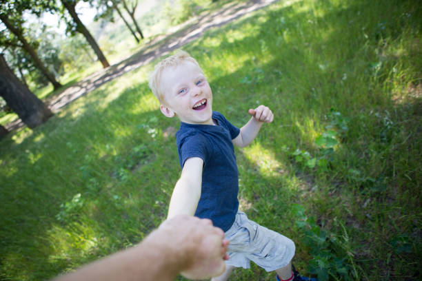 istock Boy running in circles holding dad's hand 882723068
