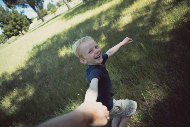 istock POV of a Boy running in circles holding dad's hand 882723294