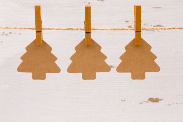 istock Three Kraft Christmas Trees Hanging on a Line 882731666