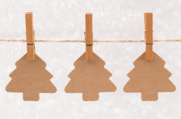 Three Kraft Christmas Trees Hanging on a Line