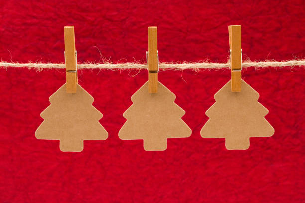 istock Three Kraft Christmas Trees Hanging on a Line 882742400