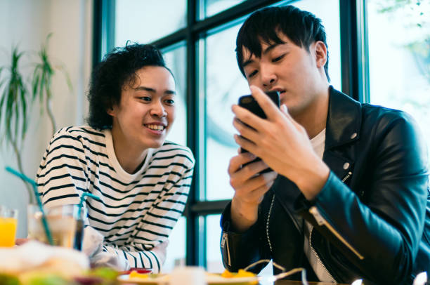 istock Laughing two young man looking at smartphone 882742972