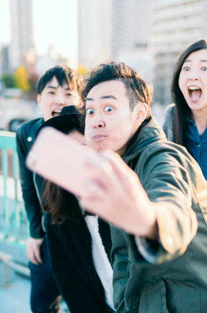 istock Group of friends taking selfie on urban rooftop 882746162
