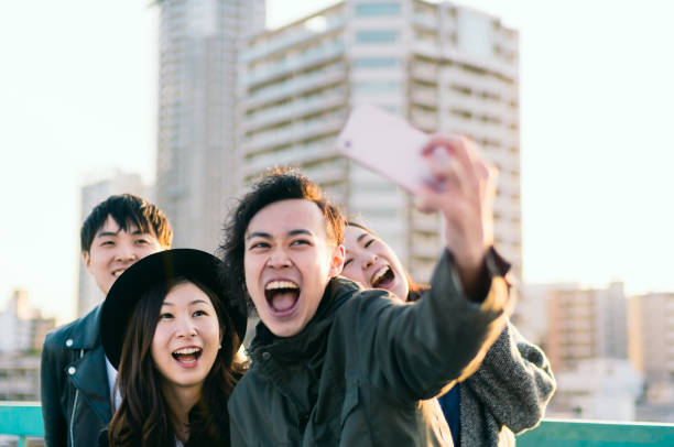 istock Group of friends taking selfie on urban rooftop 882746532
