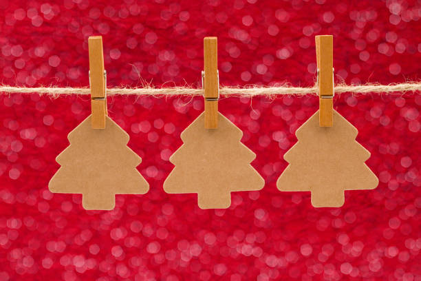 istock Three Kraft Christmas Trees Hanging on a Line 882747520