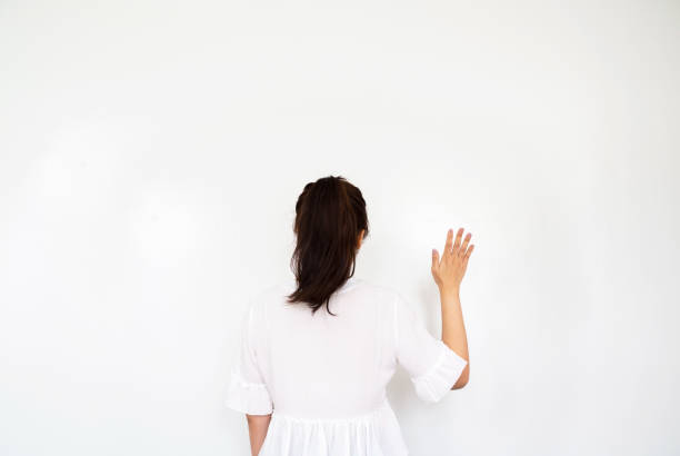 Girl making wave hand gesture on white background