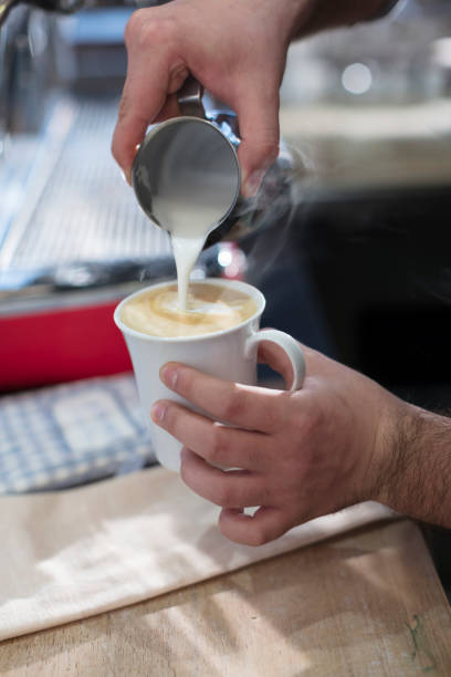 istock Close up of Hands Pouring Coffee from Jug 882773172