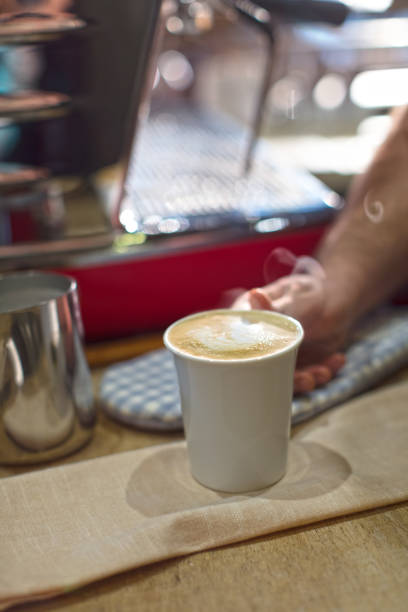 Man Holding a Cup of Cappuccino