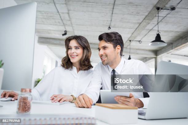 Business Colleagues Working Together In Office Stock Photo - Download Image Now - Financial Advisor, Office, Computer Monitor