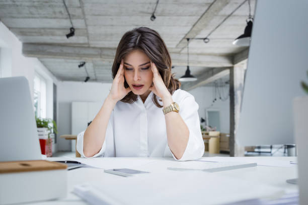 istock Stressed businesswoman suffering from headache at office 882802476