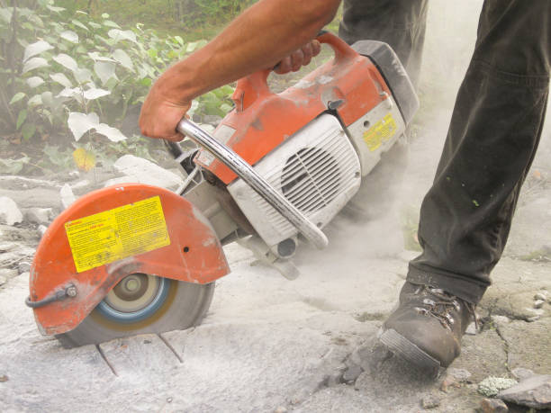 istock Man sawing on rock outcrop. Channel sample. Geology. 882802720