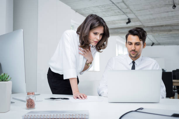 istock Business professionals working together on laptop in office 882802808