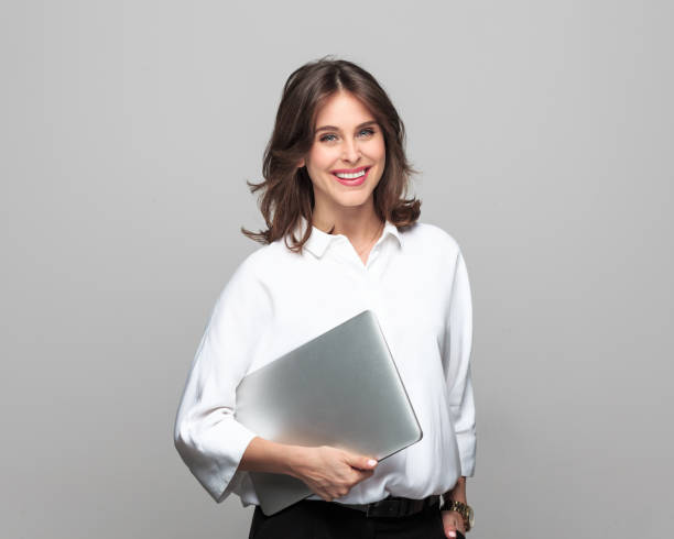 istock Smiling businesswoman standing with a laptop 882809686