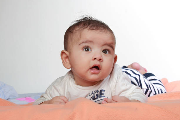 istock Cute little baby lying in the bed 882810086