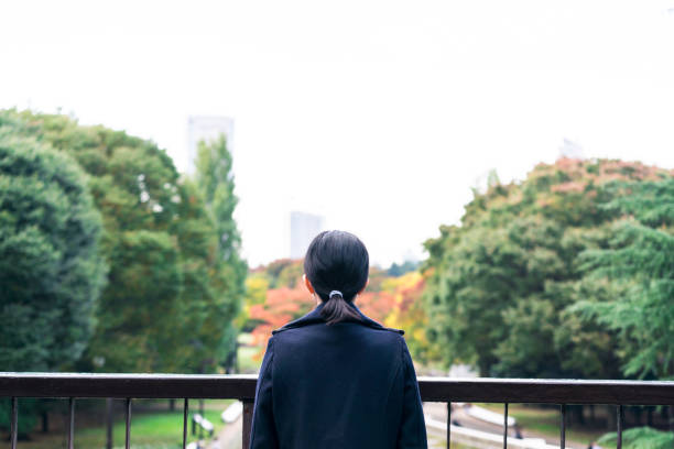 istock Woman watching from a pedestrian overpass 882810110