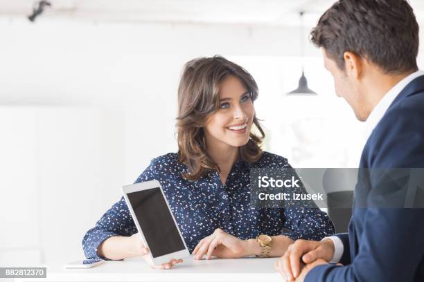 Two Business People Working Together In Office Stock Photo - Download Image Now - 20-29 Years, Adult, Adults Only