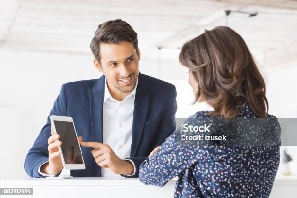 Business Colleagues Working Together In Office Stock Photo - Download Image Now - 20-29 Years, Adult, Adults Only