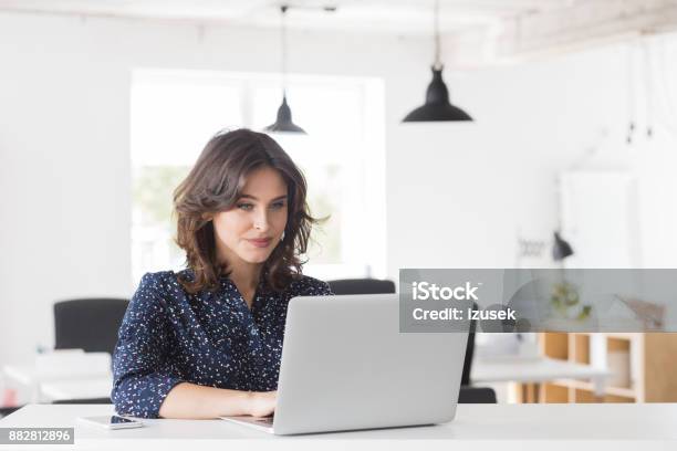 Beautiful Young Businesswoman Using Laptop Stock Photo - Download Image Now - Web Designer, Working, Businesswoman
