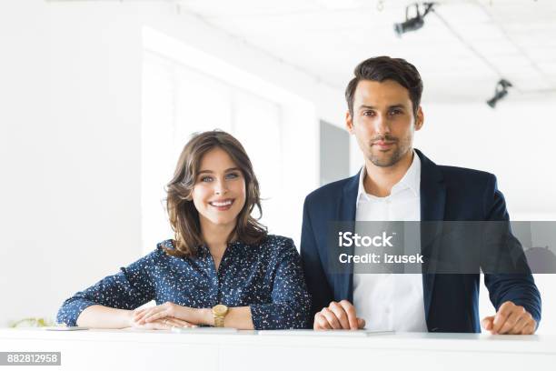 Confident Business Colleagues Together In Office Stock Photo - Download Image Now - 20-29 Years, Adult, Adults Only