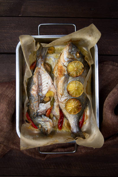 istock Oven baked sea bream with lime, chilli and ginger 882824544