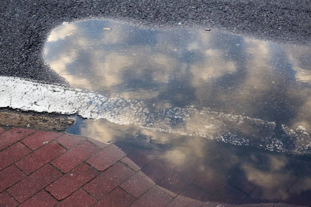 istock Puddle of water, Reflection of the sky 882825230