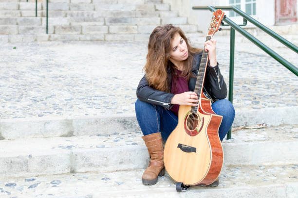 istock Focused Woman with Guitar Picking Song 882827550
