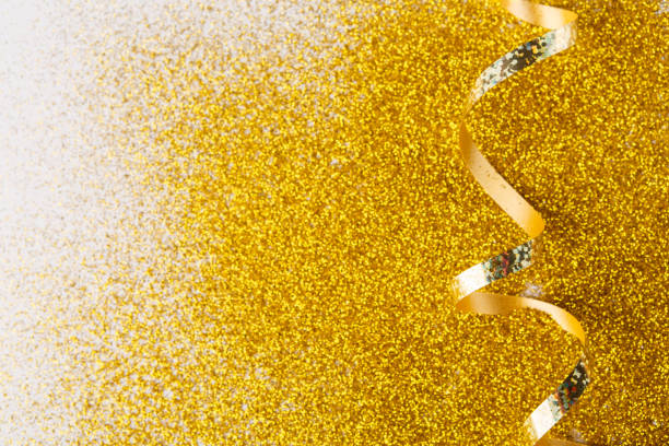 istock Curly golden serpentine on glitter background 882830644
