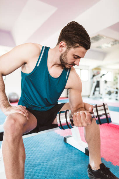 istock fitness man showing the bicep 882835482