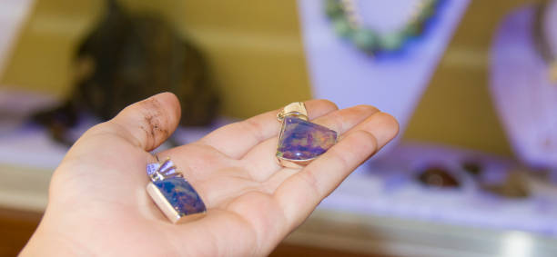istock silver pendants with the blue amber in ultraviolet light 882836564