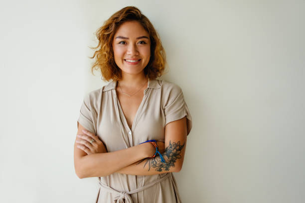 istock Positive Asian woman looking at camera and smiling 882843056