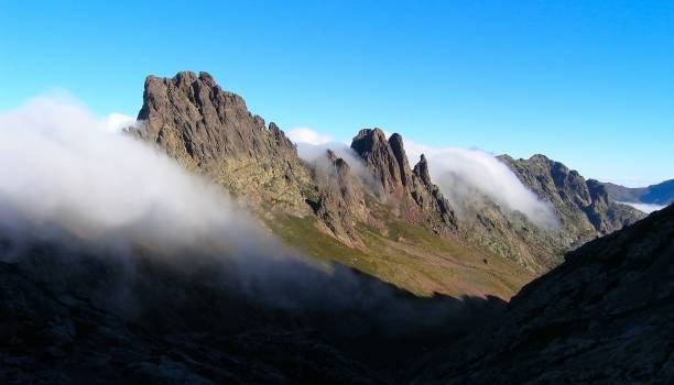 istock Mountains and creeping clouds, Corsica 882844070