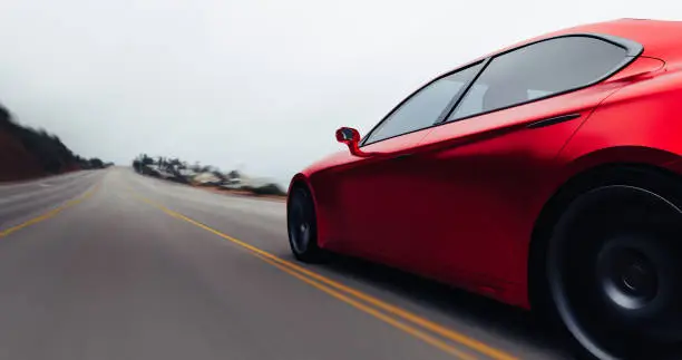 Photo of car driving on a road by sea