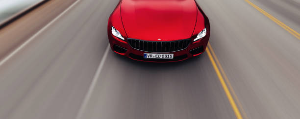 istock car driving on a road by sea 882847374