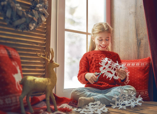 istock girl by window at Christmas 882856038
