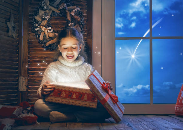 istock girl by window at Christmas 882856072