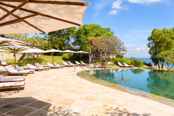 istock Nice tropical pool side with sun-loungers und sun umbrellas 882856138