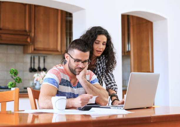 istock Couple receiving home bills 882856954
